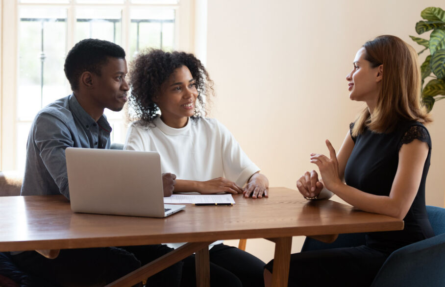 A young couple talking to a lettings agent