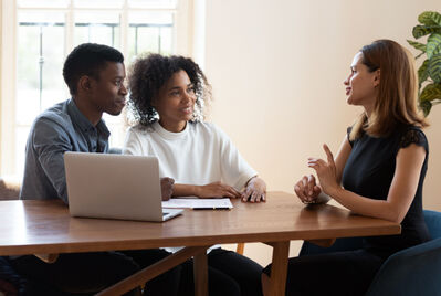 A young couple talking to a lettings agent