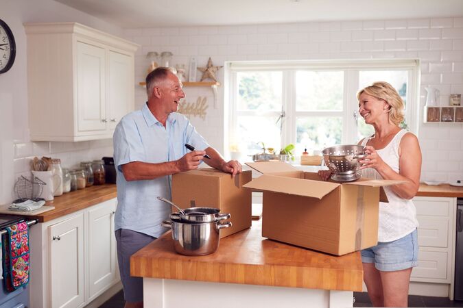 A couple packing up in their kitchen
