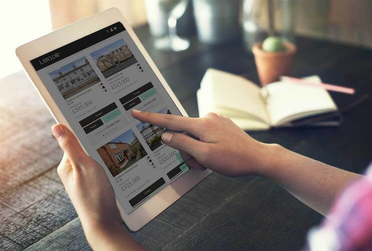 Landlord looking at investment properties on laptop