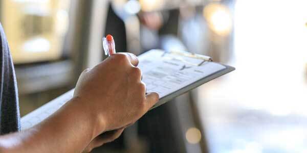 property management team with clipboard, checking off list