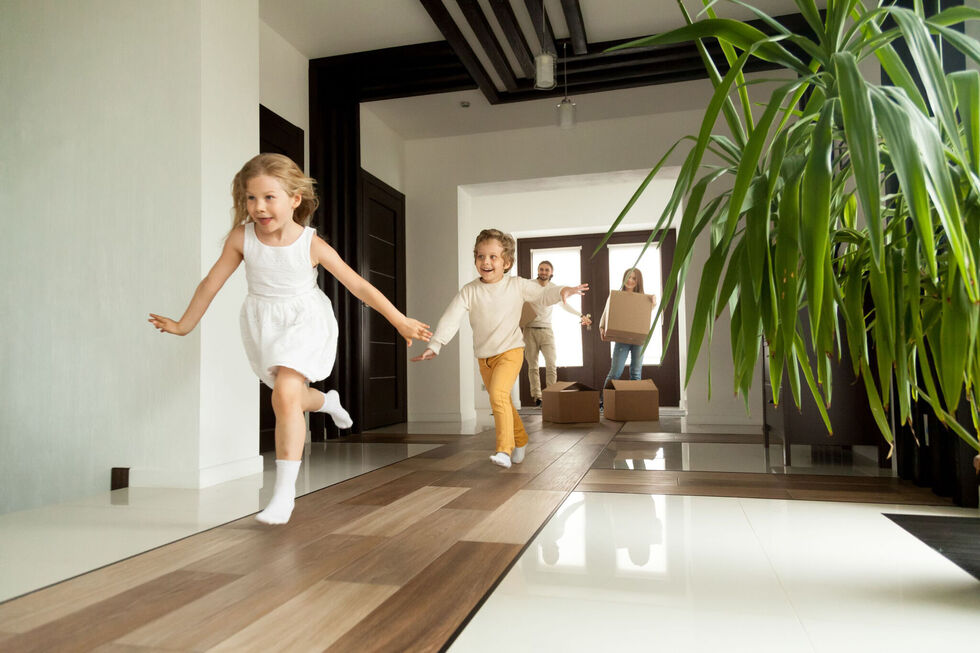 Children running into a new home