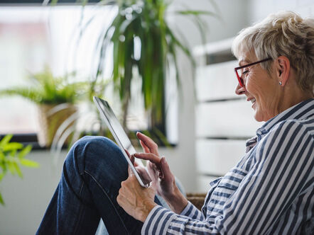 Senior woman using tablet at home