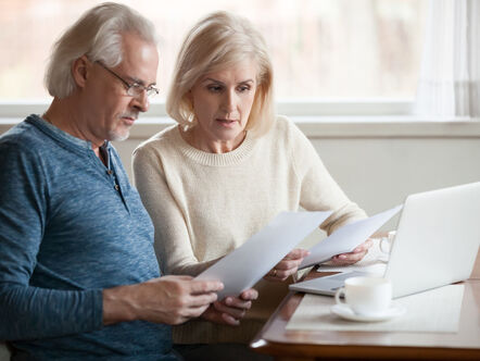 senior couple reading landlord documents 