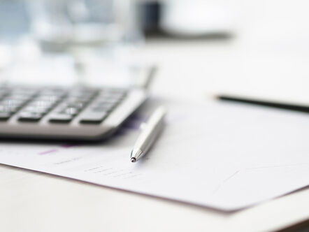 silver pen and calculator on document