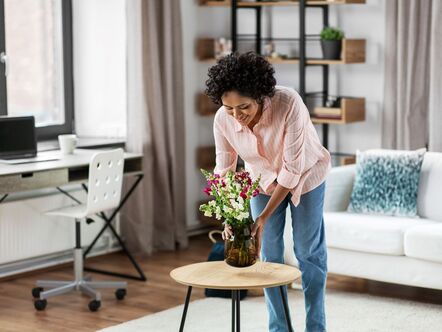 A woman putting flowers on a table