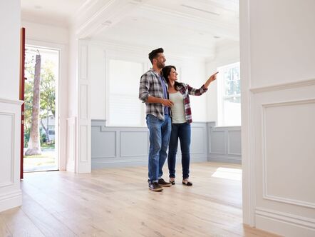 A couple looking round an empty house