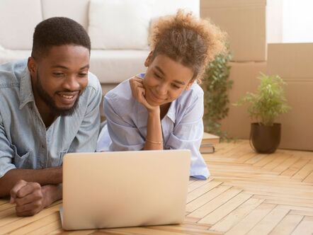 Two people looking at a laptop together