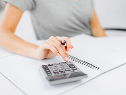 Woman working out budget with calculator